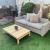 Outdoor rattan sofa with cushions and wooden table